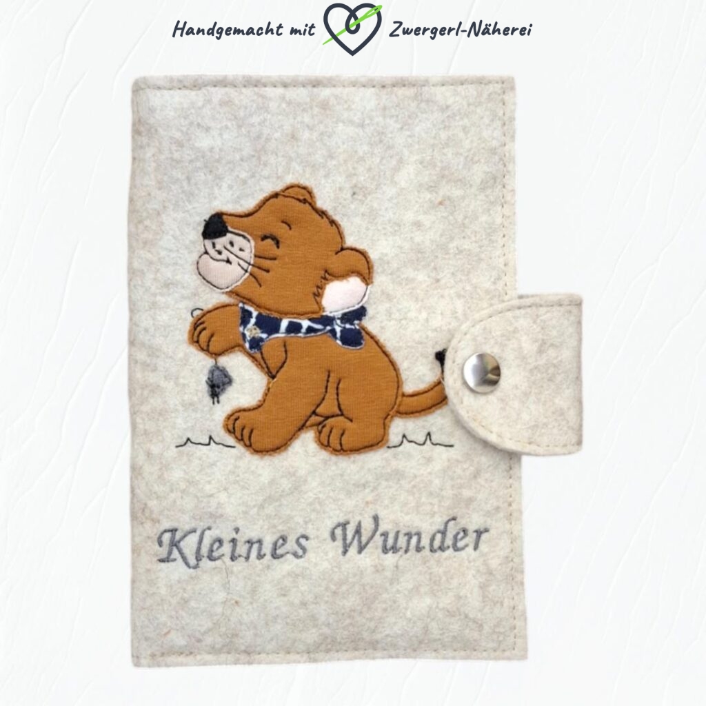 Mutterkindpass Hülle Filz handmade personalisiert mit Löwen-Baby Stick-Applikation und Spruch Vorderansicht